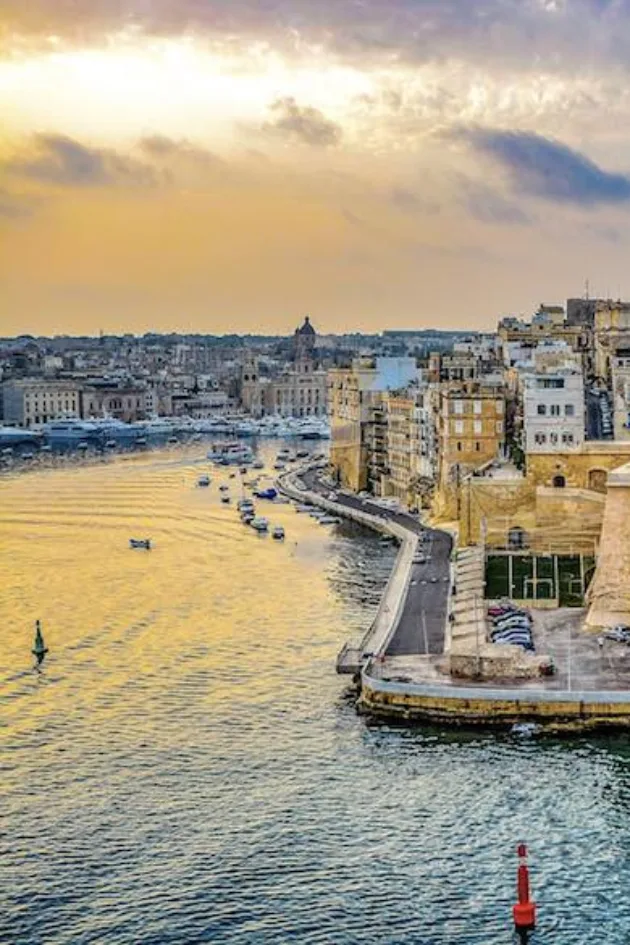 Golden evening light over the harbour beside the Three Cities