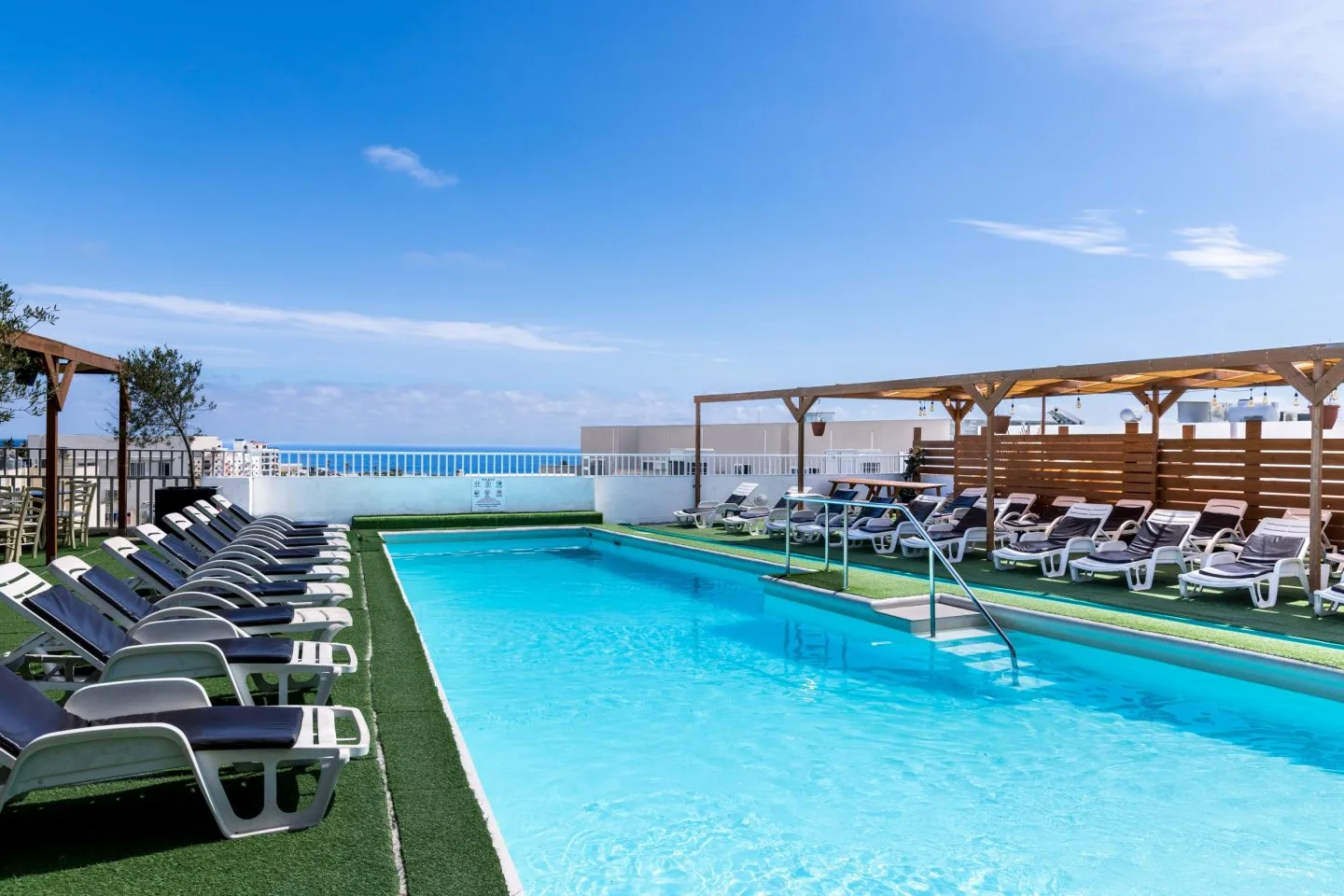 Sun loungers on the rooftop pool terrace at Cerviola Hotel