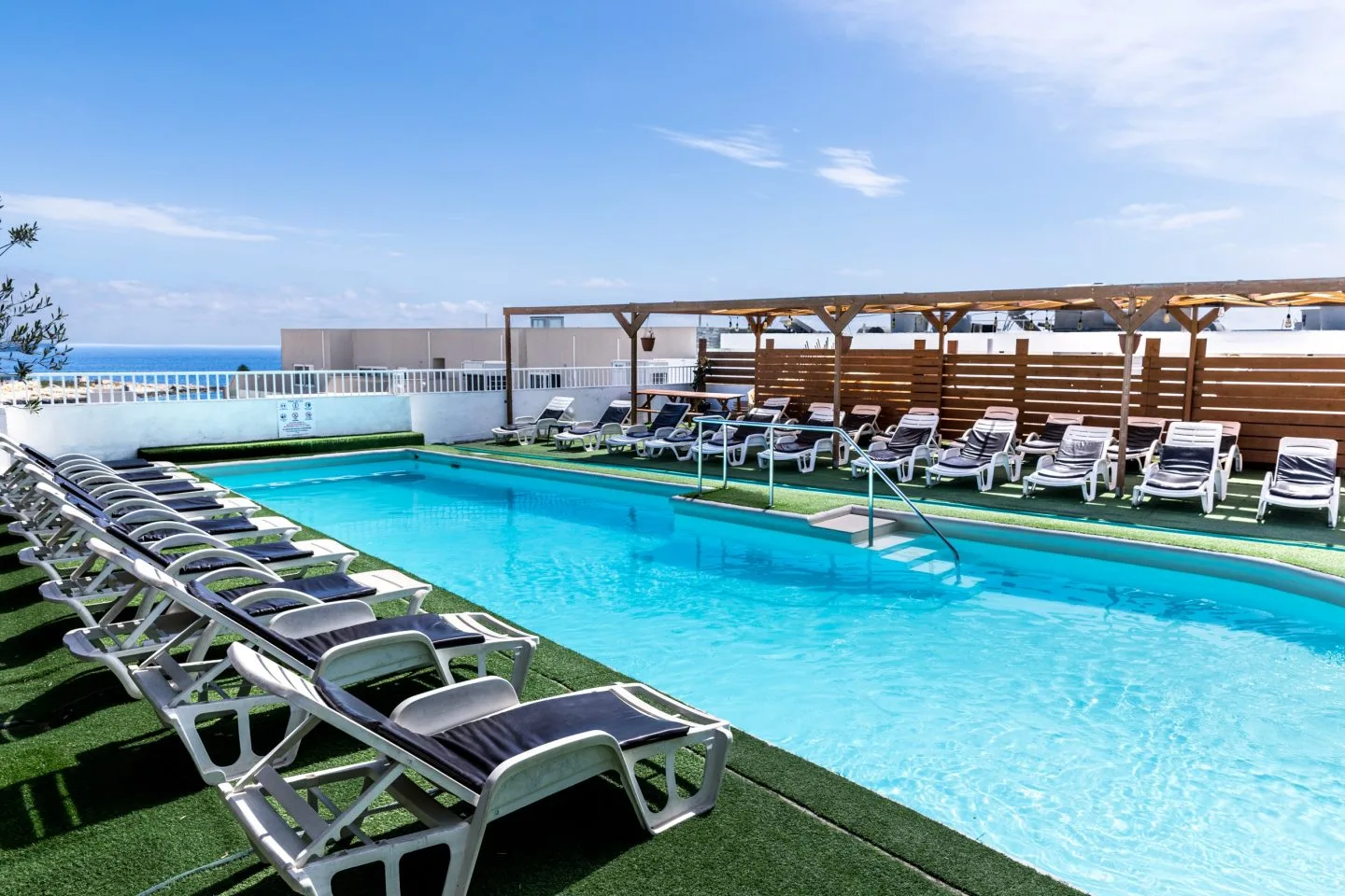 The seasonal rooftop pool and sun loungers